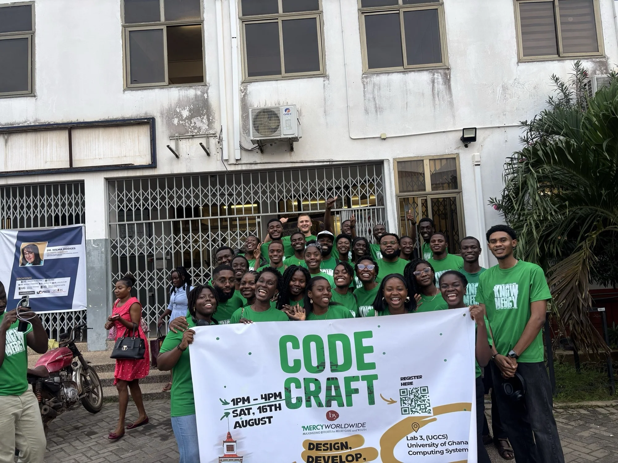The full Code Craft cohort gathered outside the venue behind a Code Craft banner.
