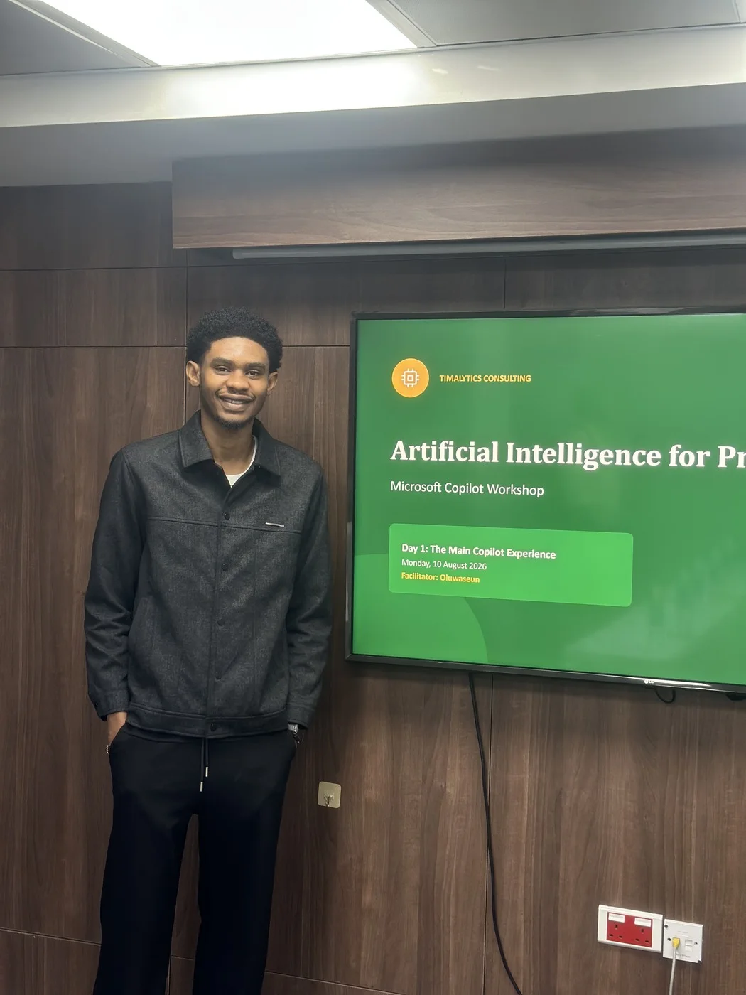 A facilitator standing beside the Artificial Intelligence for Productivity title slide at the start of the workshop.