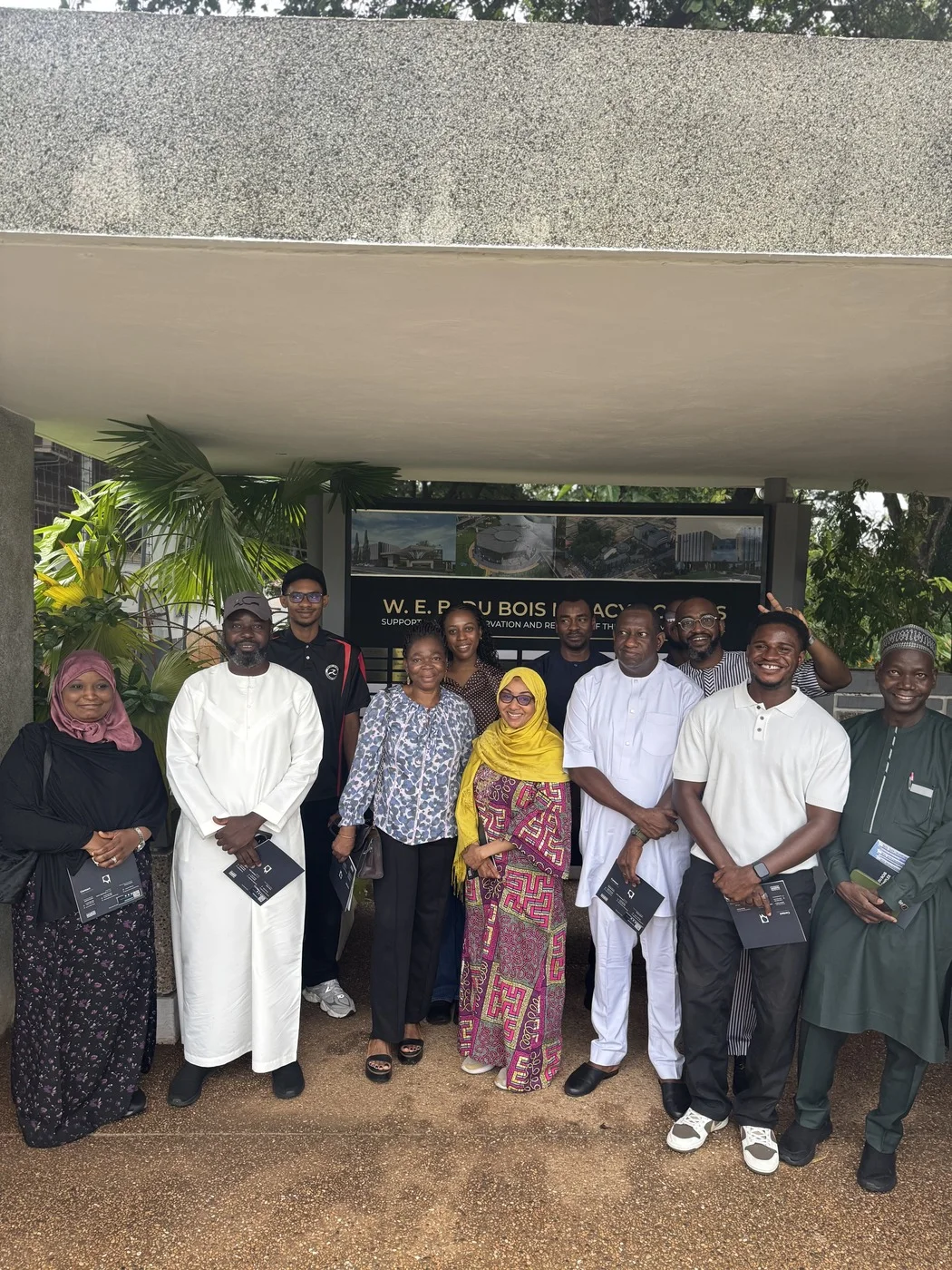 Participants outside the W. E. B. Du Bois Memorial Centre in Accra, Ghana, holding course folders.