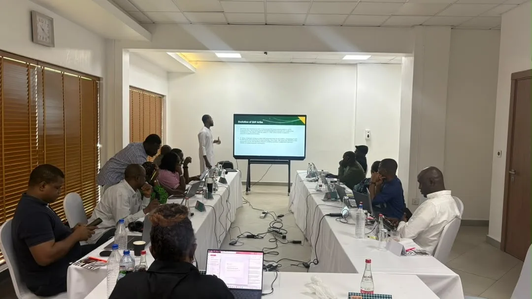 A facilitator presenting a slide titled Evolution of SAP Ariba to a room of participants.